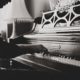black and white photo of someone playing the piano