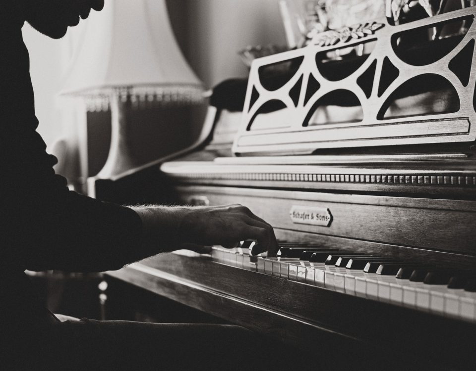 black and white photo of someone playing the piano